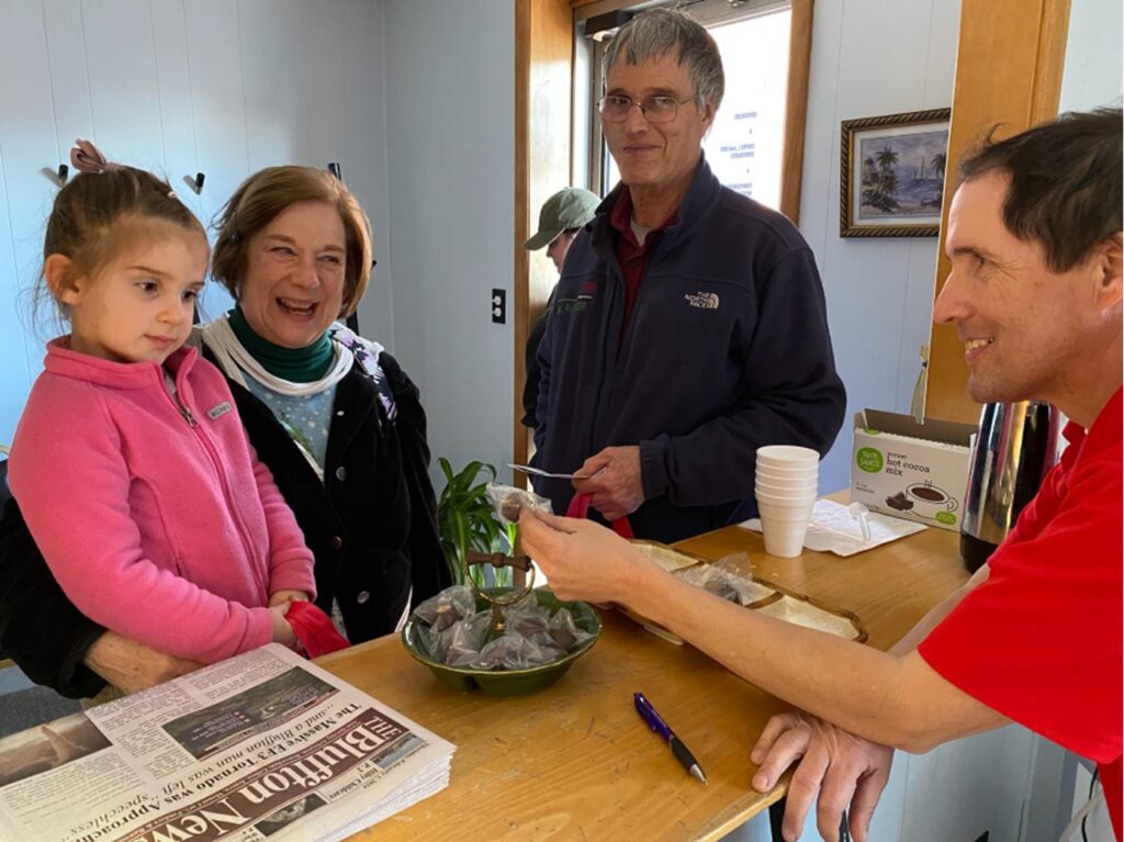 The Bluffton News Publisher Joe Gilroy on Feb. 8 hands out a Buckeye to this happy young lady with a sweet tooth during Bluffton’s Chocolate Walk.  "I'll give you this piece of candy, if you talk your folks into getting a subscription." JUST KIDDING!  TBN photo/Joe Schriner